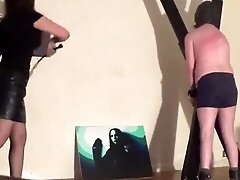 Miss Sultrybelle whips a male sub with a single tail.