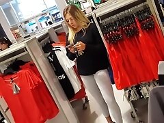 Candid hot blonde in leggings shopping