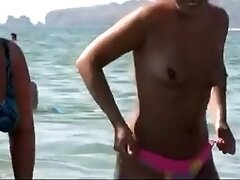 See those smooth nudists play at a public beach